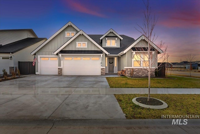 craftsman inspired home featuring a lawn and a garage