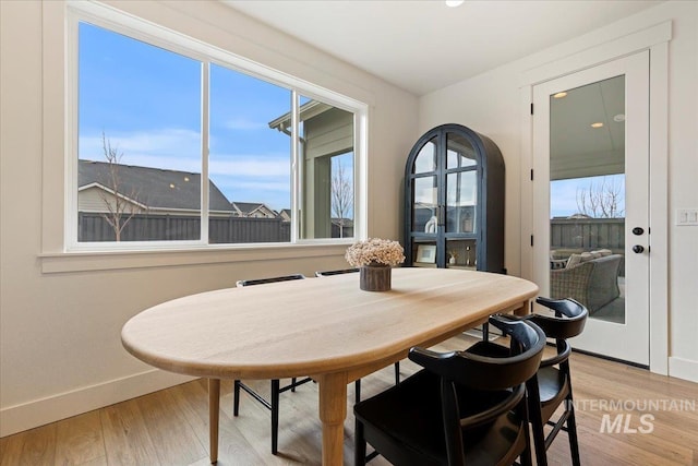 dining space with light hardwood / wood-style flooring