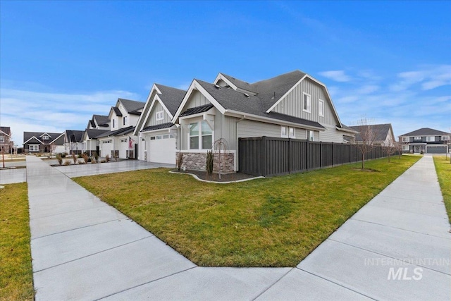 view of side of property featuring a garage and a lawn