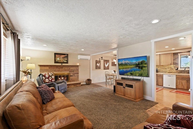14525 Woosley, Nampa, ID 83651 - living room featuring a wall unit AC, a textured ceiling, a fireplace, recessed lighting, and light carpet