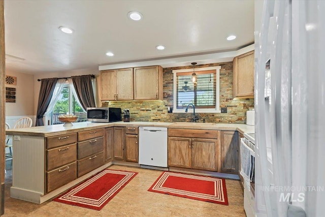 14525 Woosley, Nampa, ID 83651 - kitchen with dishwasher, a peninsula, stainless steel microwave, a sink, and tasteful backsplash