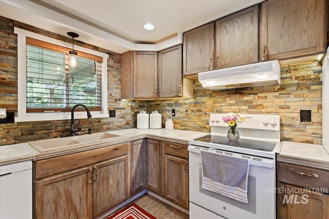 14525 Woosley, Nampa, ID 83651 - kitchen with white appliances, under cabinet range hood, a sink, tasteful backsplash, and light countertops