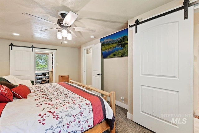14525 Woosley, Nampa, ID 83651 - bedroom with a barn door, baseboards, ceiling fan, and carpet flooring