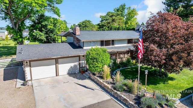14525 Woosley, Nampa, ID 83651 - view of front of house with an attached garage, concrete driveway, a chimney, and roof with shingles
