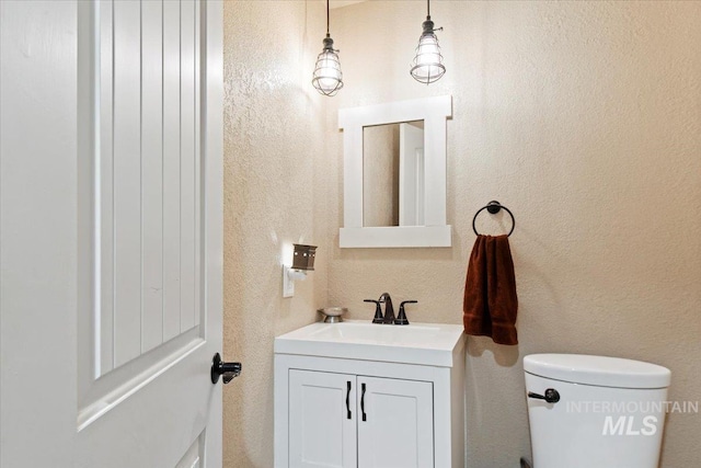 14525 Woosley, Nampa, ID 83651 - bathroom featuring vanity, toilet, and a textured wall