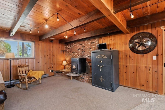 14525 Woosley, Nampa, ID 83651 - living area with rail lighting, carpet, a wood stove, wood walls, and wooden ceiling with exposed beams