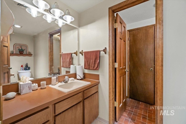 bathroom with toilet and vanity