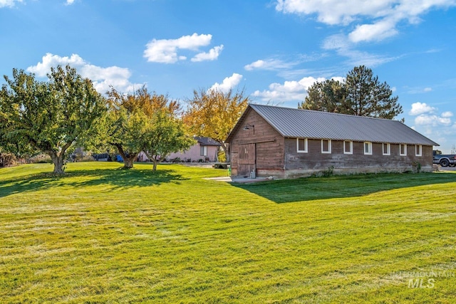 view of side of home with a lawn