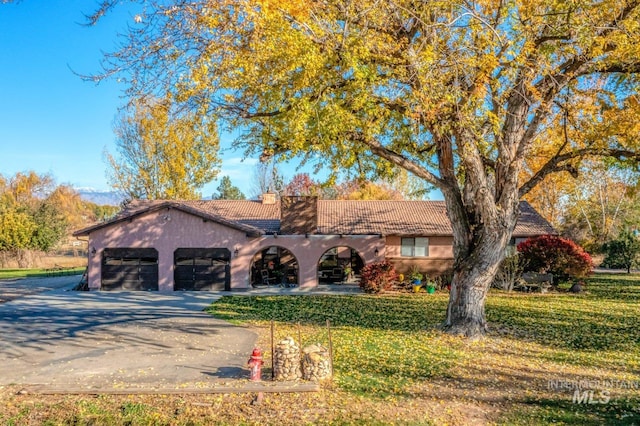 ranch-style house with a front yard and a garage