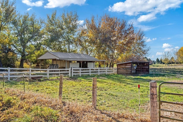 view of horse barn featuring a rural view