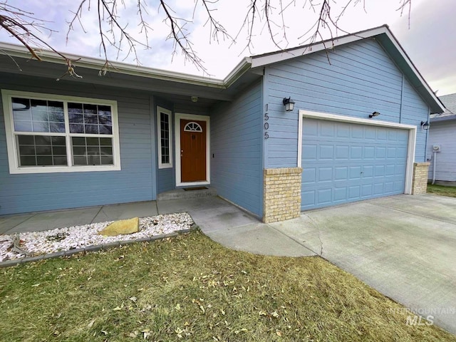 ranch-style house with brick siding, driveway, and an attached garage