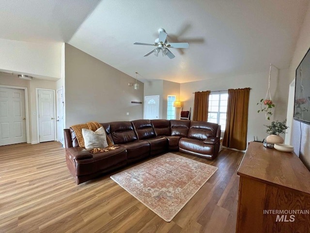 living room featuring lofted ceiling, ceiling fan, and wood finished floors