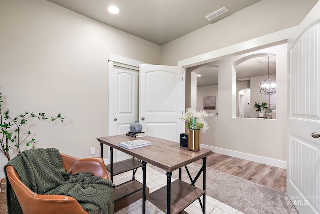 office with visible vents, baseboards, recessed lighting, light wood-style floors, and arched walkways