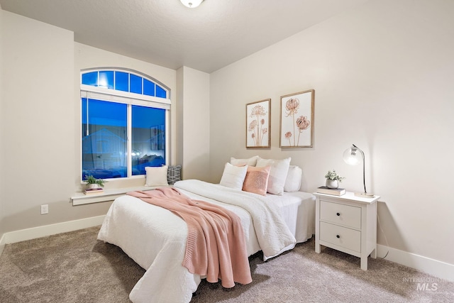 bedroom featuring carpet flooring and baseboards