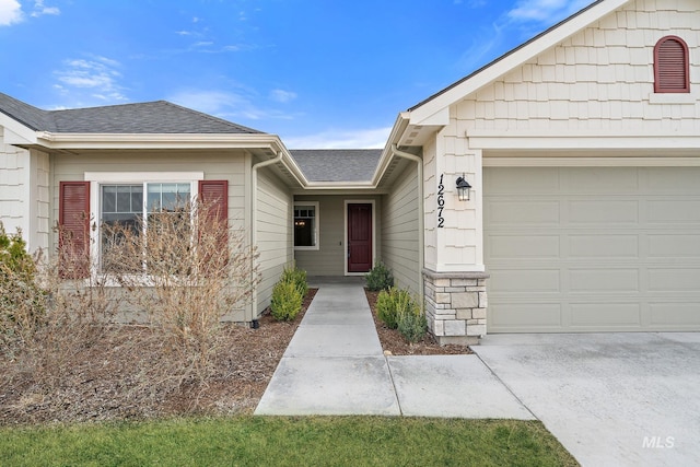 property entrance with an attached garage, stone siding, and roof with shingles