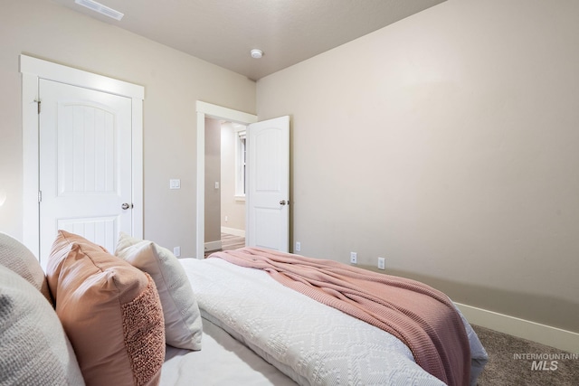 bedroom with visible vents, carpet flooring, and baseboards