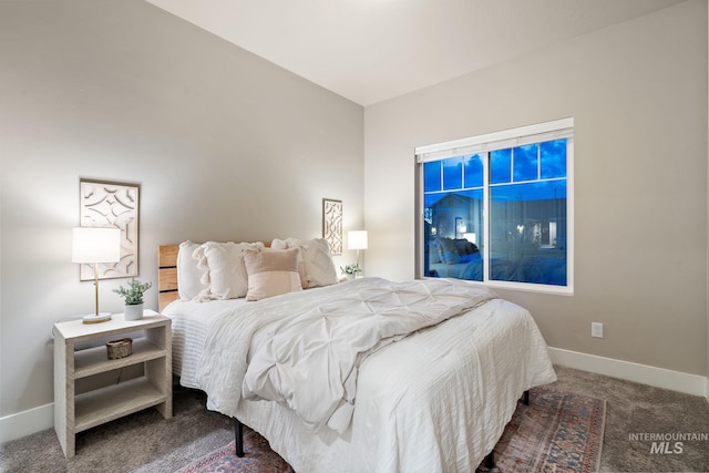 carpeted bedroom featuring baseboards