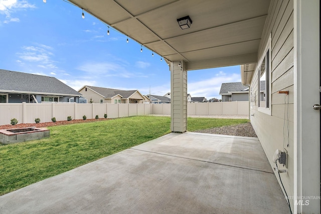 view of patio / terrace featuring a vegetable garden, a residential view, and a fenced backyard