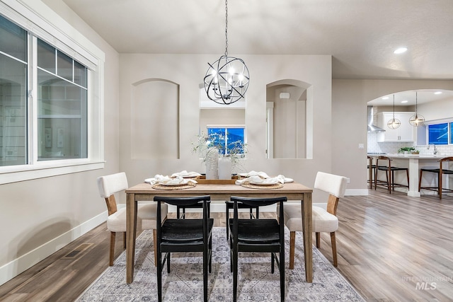 dining area featuring visible vents, baseboards, recessed lighting, wood finished floors, and a notable chandelier