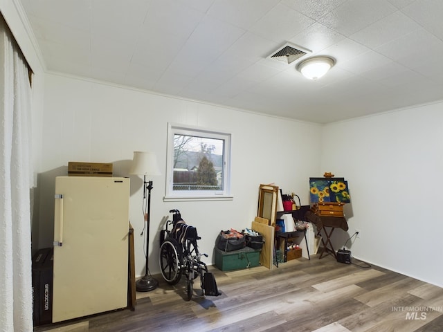 misc room featuring hardwood / wood-style floors and crown molding