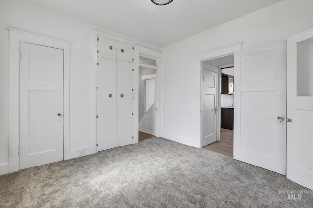 unfurnished bedroom featuring a closet and carpet flooring