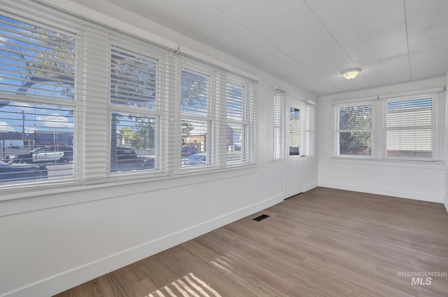 unfurnished sunroom featuring visible vents