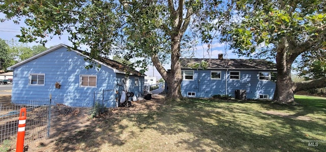 rear view of house with a lawn