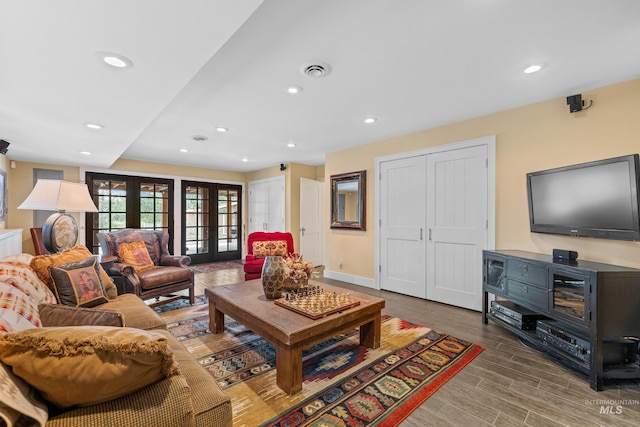 living room with french doors, recessed lighting, visible vents, wood finished floors, and baseboards