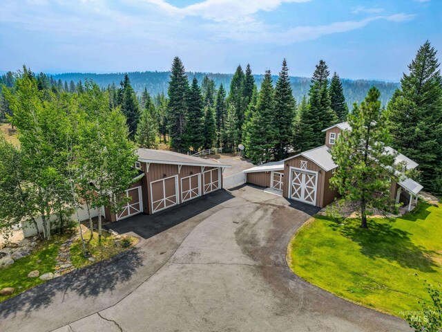 exterior space featuring an outbuilding, a hot tub, and a wooden deck