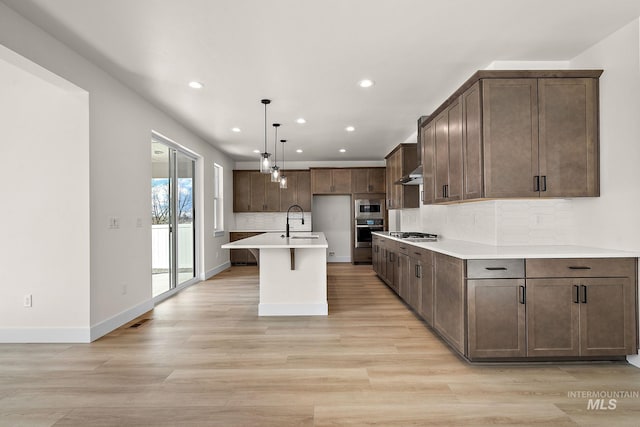 664 E Lockhart St, Meridian, ID 83646 - kitchen featuring wall chimney range hood, tasteful backsplash, a sink, stainless steel appliances, and recessed lighting