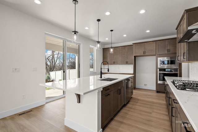 664 E Lockhart St, Meridian, ID 83646 - kitchen featuring a sink, tasteful backsplash, recessed lighting, light countertops, and appliances with stainless steel finishes