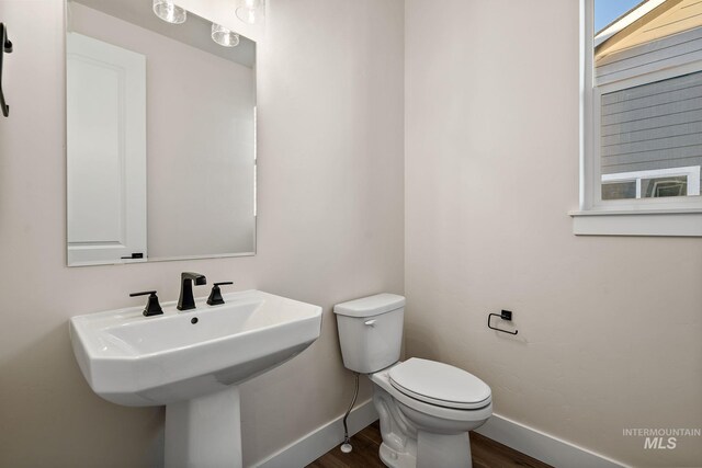 664 E Lockhart St, Meridian, ID 83646 - bathroom featuring wood finished floors, toilet, baseboards, and a sink