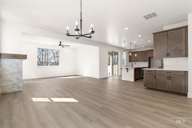 664 E Lockhart St, Meridian, ID 83646 - unfurnished living room featuring ceiling fan with notable chandelier, light wood-style floors, visible vents, and recessed lighting