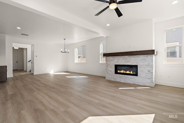 664 E Lockhart St, Meridian, ID 83646 - unfurnished living room featuring ceiling fan with notable chandelier, baseboards, light wood-type flooring, and visible vents