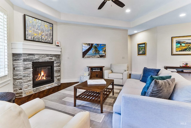 living area featuring a fireplace, ceiling fan, and recessed lighting