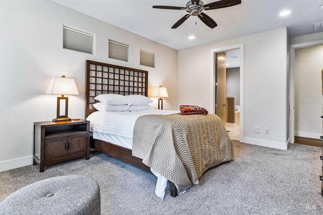 carpeted bedroom featuring recessed lighting, baseboards, ensuite bath, and ceiling fan