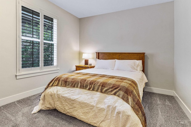 carpeted bedroom featuring baseboards