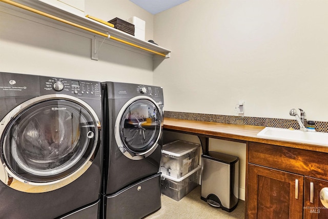 laundry room featuring washer and clothes dryer and cabinet space