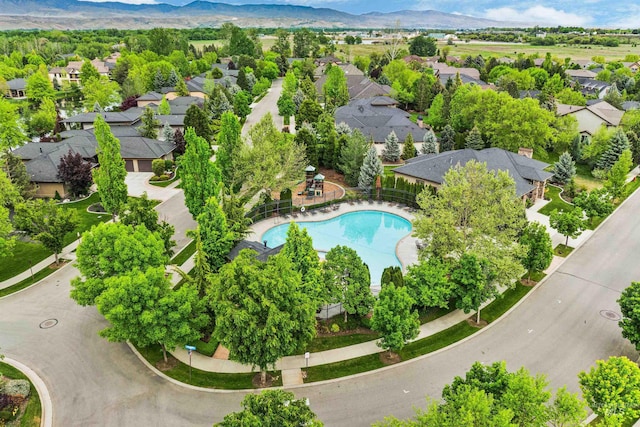 aerial view of residential area with mountains and a pool area