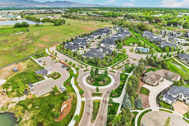 aerial view of property's location with a water and mountain view and nearby suburban area