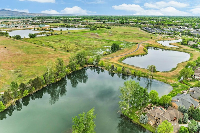 view of property location featuring a nearby body of water and nearby suburban area