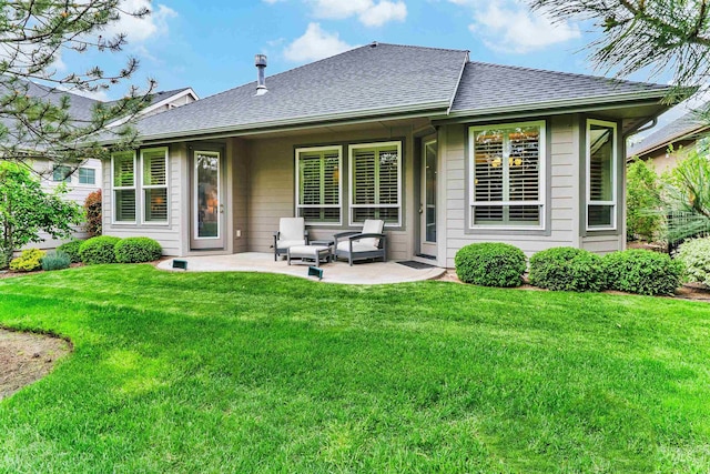 back of property featuring a shingled roof, a patio, and a yard