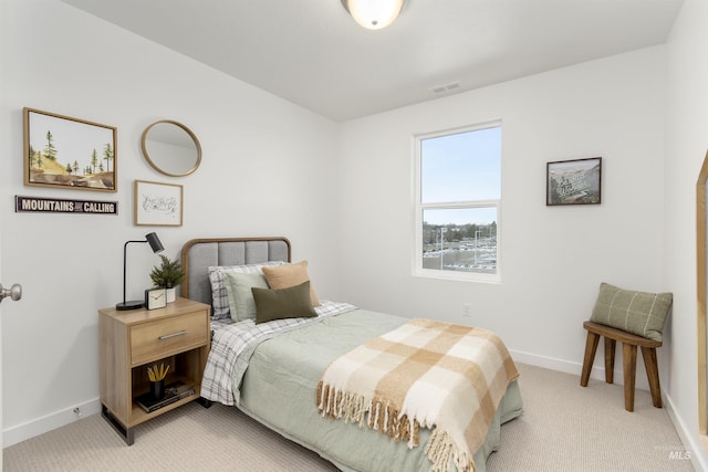 bedroom featuring light carpet