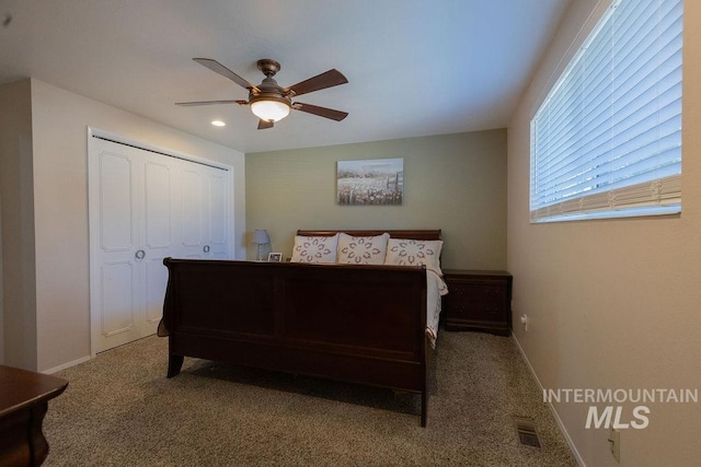 bedroom featuring a closet, visible vents, carpet floors, and baseboards
