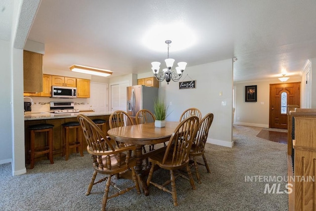 dining area with light carpet, a chandelier, and baseboards