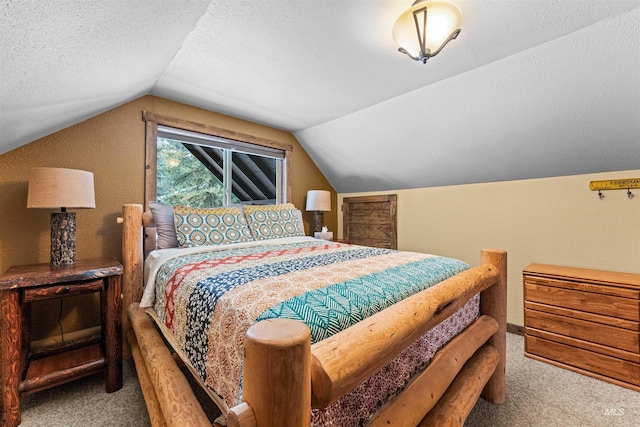 carpeted bedroom with a textured ceiling and lofted ceiling