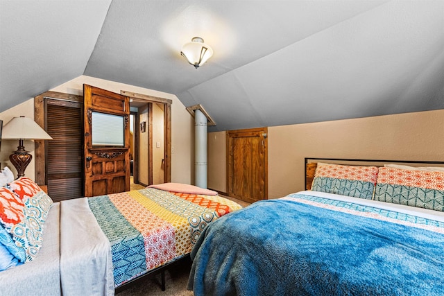 bedroom with carpet and vaulted ceiling