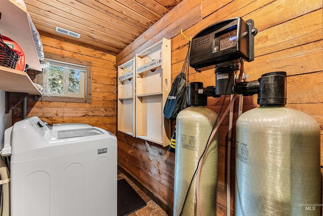 washroom with washing machine and dryer, wood ceiling, and wooden walls