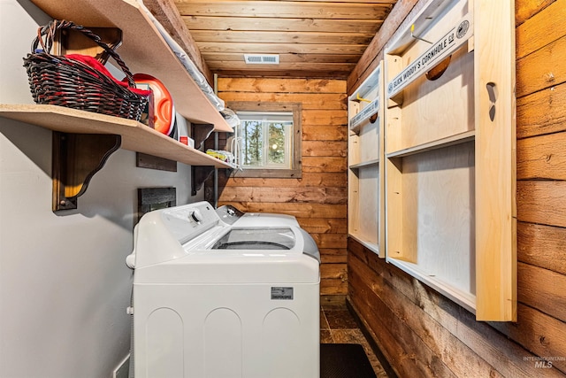 washroom featuring wooden walls, wooden ceiling, and independent washer and dryer