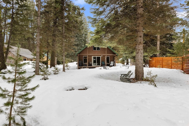 yard layered in snow featuring an outbuilding